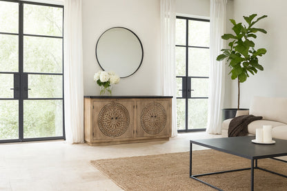 Living room with wooden sideboard, round mirror, and modern decor