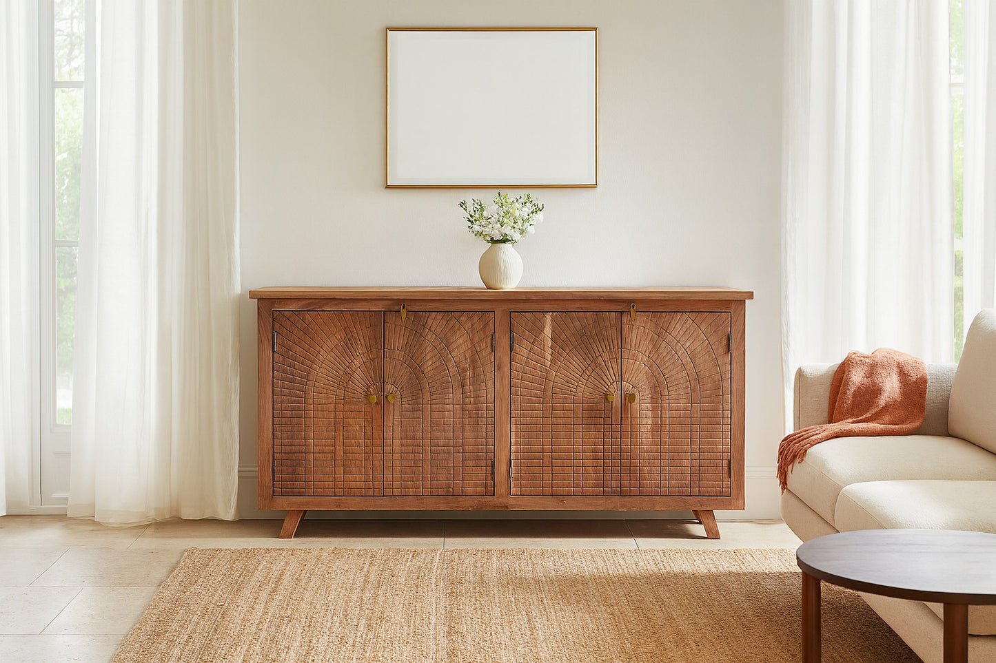 Wooden sideboard in a living room with a vase and framed picture on a white wall.