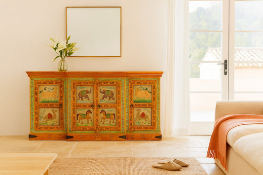 Decorative wooden sideboard with animal illustrations in a living room setting.