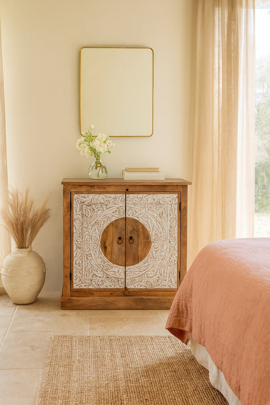 Wooden cabinet with decorative design in a bedroom setting