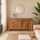 Wooden sideboard in a room with a mirror and plants