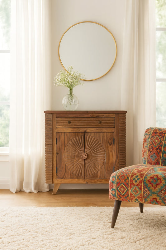 Wooden cabinet with decorative sunburst pattern in a room with a colorful chair and round mirror.