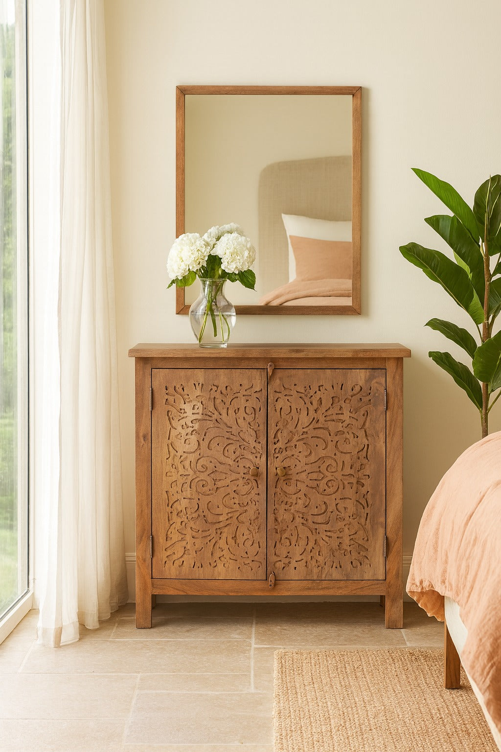 Wooden cabinet with floral arrangement in a room with a mirror and plant
