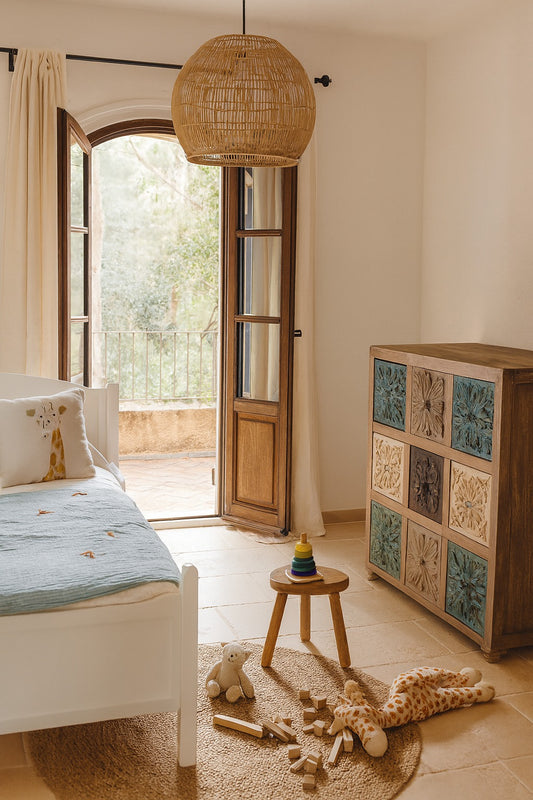 Children's bedroom with a bed, wooden cabinet, and toys on the floor.