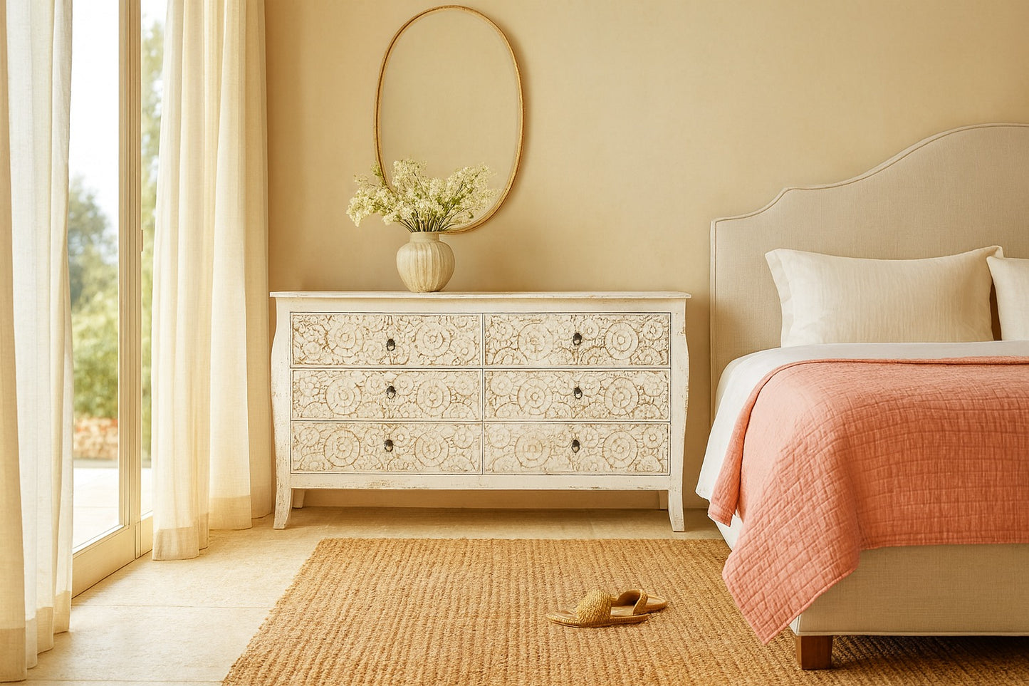 Decorative chest of drawers in a bedroom with a bed and floral arrangement.