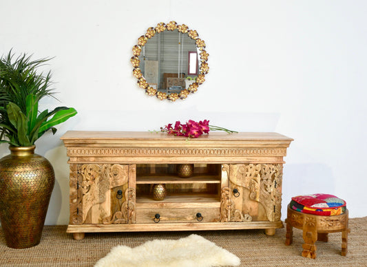 Wooden TV stand with decorative elements in a room setting