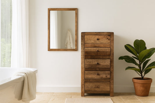 Wooden dresser with mirror and plant in a room setting