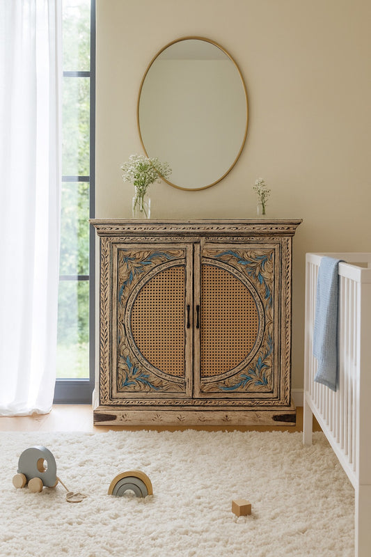 Decorative wooden cabinet with wicker doors in a room with a crib and toys.