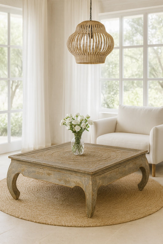 Living room with a wooden coffee table, white sofa, and decorative lamp.